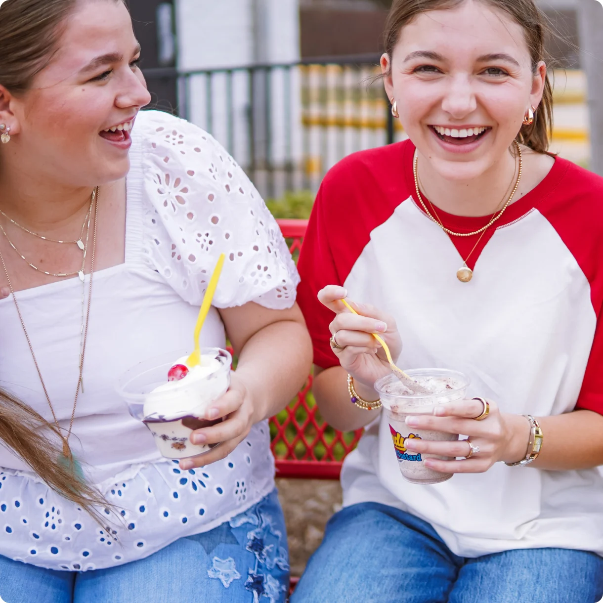 Two friends laughing over Andy’s custard on the patio