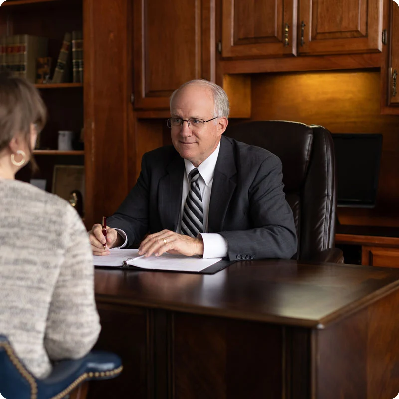A Ramey Flock attorney at his desk with a client